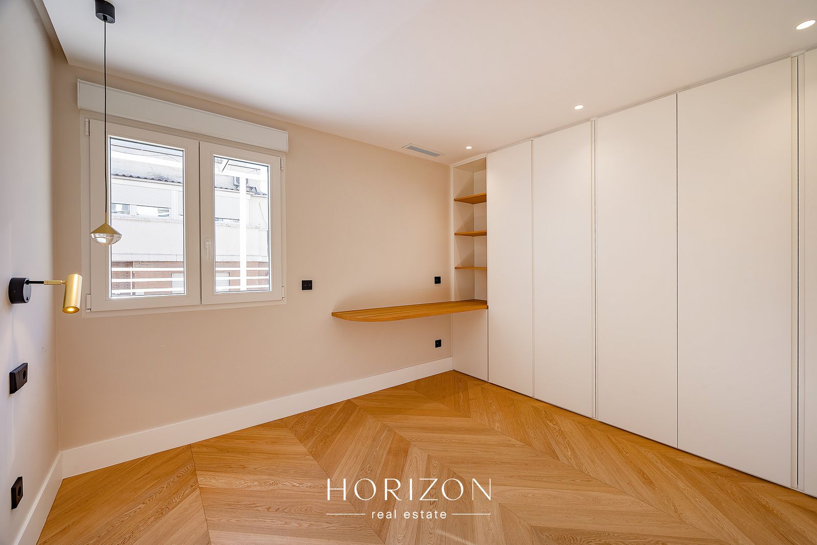 Second bedroom with desk and wardrobes