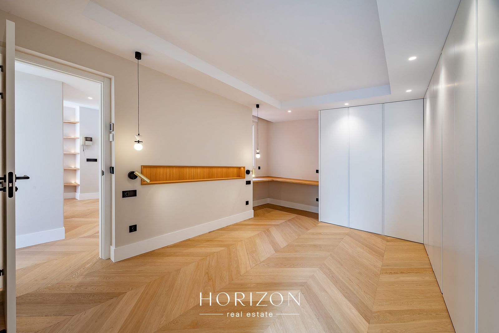Bedroom with built-in wardrobes and desk after renovation