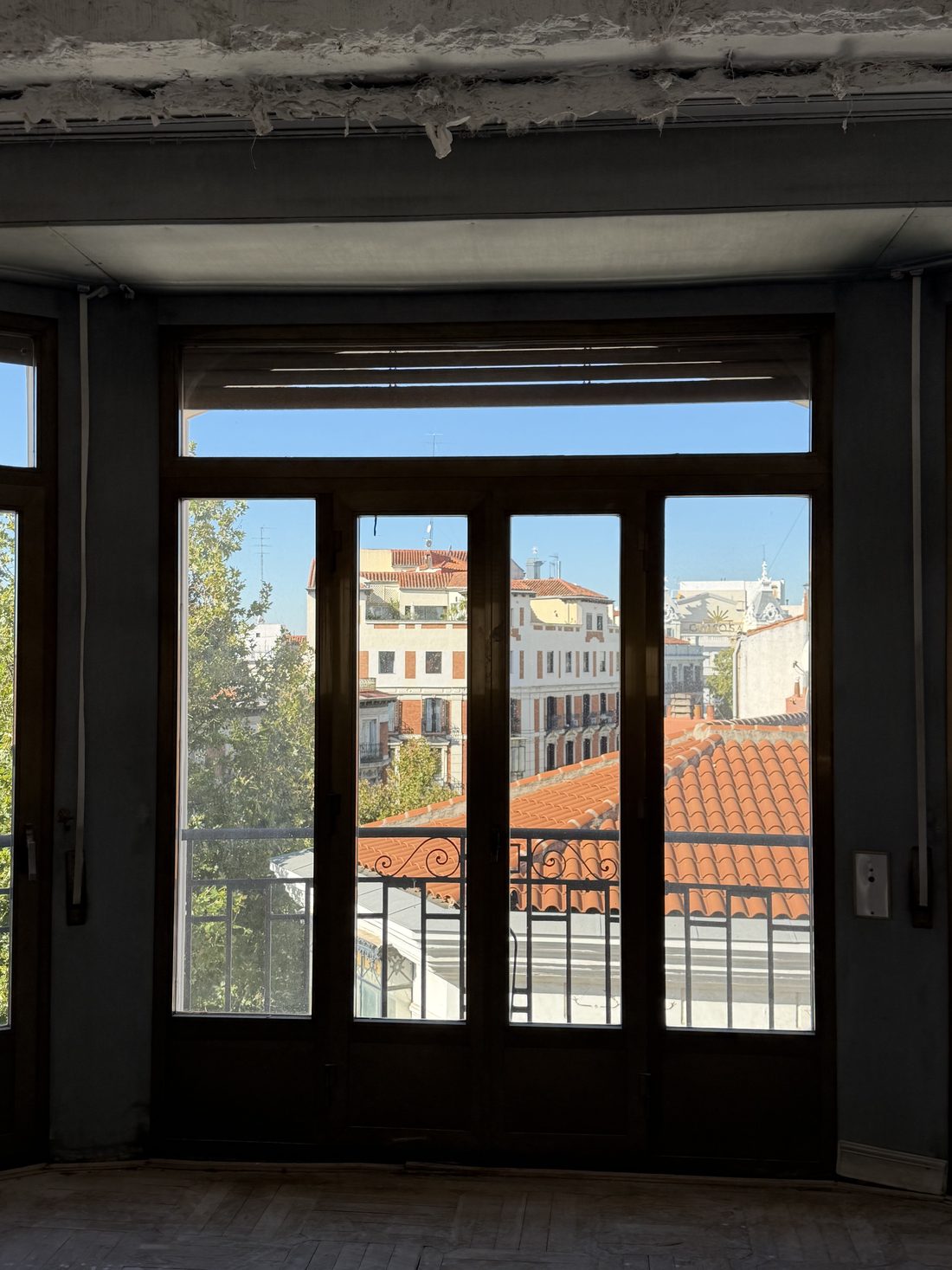 Floor-to-ceiling windows overlooking the rooftops